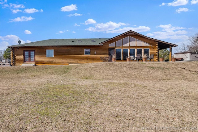 rear view of property with a yard, a patio, log exterior, and french doors