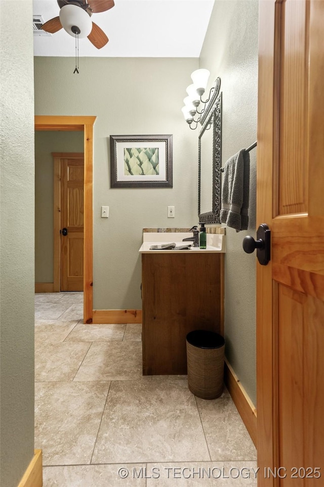 bathroom with a ceiling fan, tile patterned flooring, vanity, and baseboards