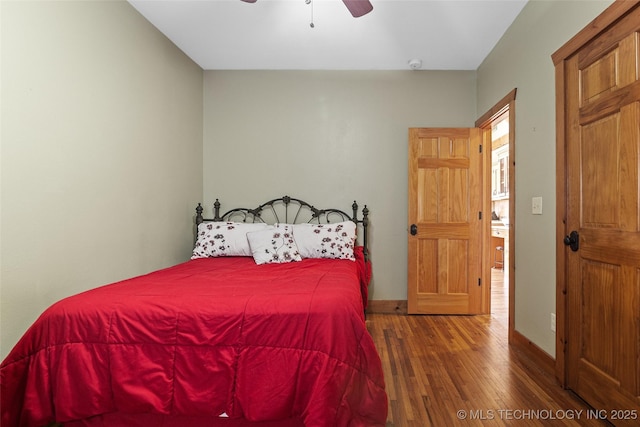 bedroom with wood finished floors, a ceiling fan, and baseboards