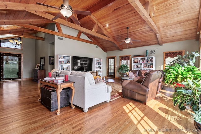 living area with visible vents, wooden ceiling, light wood-style flooring, beamed ceiling, and ceiling fan with notable chandelier