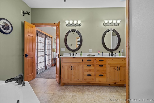 bathroom with a tub to relax in, a sink, french doors, tile patterned floors, and double vanity