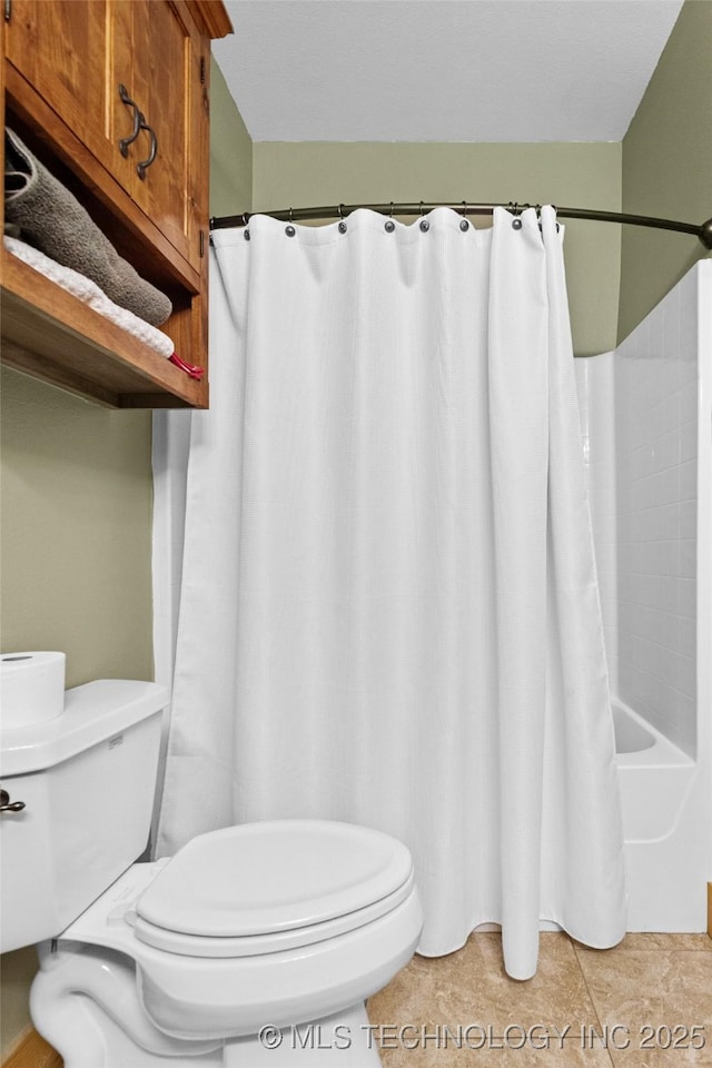 bathroom featuring shower / tub combo, toilet, and tile patterned floors