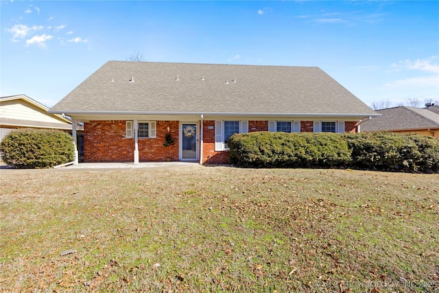 ranch-style house with brick siding, a front lawn, and roof with shingles