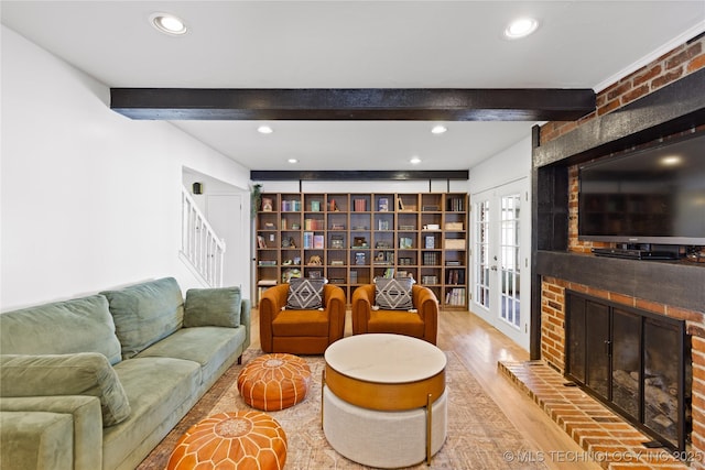 living area with a brick fireplace, wood finished floors, beam ceiling, and recessed lighting