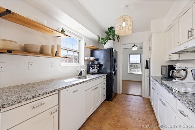 kitchen featuring dishwasher, electric stovetop, white cabinetry, open shelves, and a sink