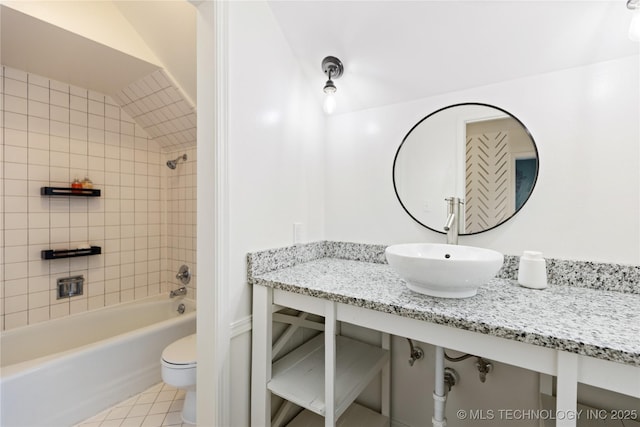 bathroom with toilet, shower / bath combination, a sink, and tile patterned floors