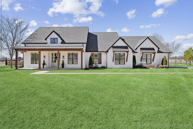 modern inspired farmhouse with metal roof, roof with shingles, board and batten siding, a front lawn, and a standing seam roof