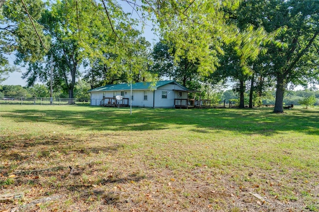 view of yard featuring fence and a deck