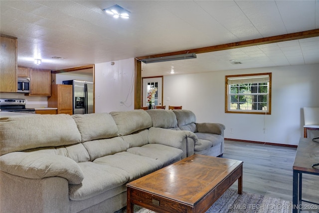 living room featuring light wood-style floors and baseboards