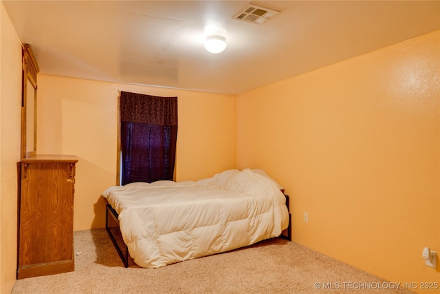 carpeted bedroom featuring visible vents