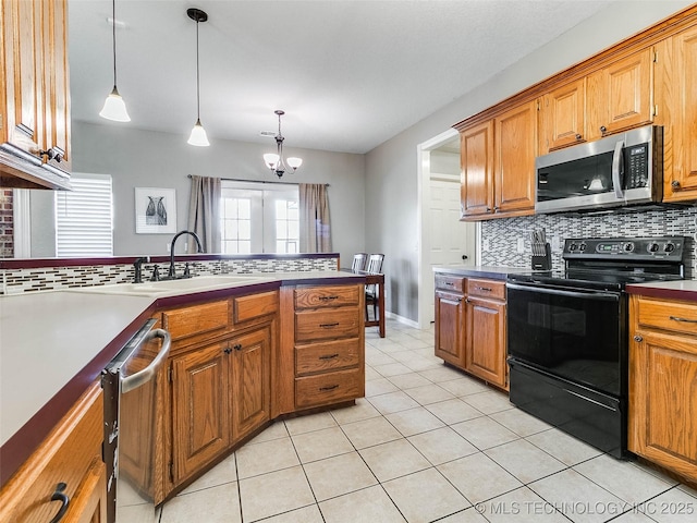 kitchen with appliances with stainless steel finishes, brown cabinetry, and backsplash