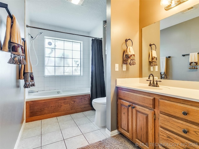 full bathroom with visible vents, toilet, tile patterned floors, shower / bath combo with shower curtain, and vanity