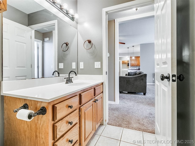 bathroom with baseboards, vanity, and tile patterned floors