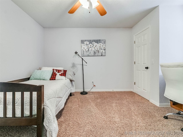 carpeted bedroom with ceiling fan and baseboards