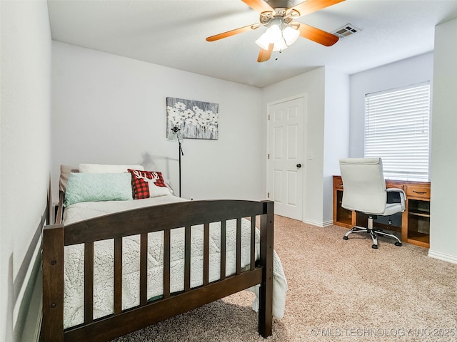 bedroom featuring a ceiling fan, carpet flooring, visible vents, and baseboards