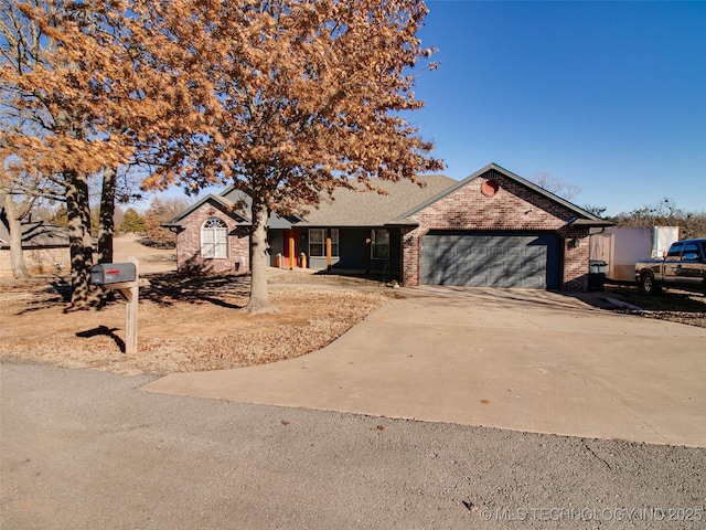 ranch-style house featuring concrete driveway, brick siding, and an attached garage