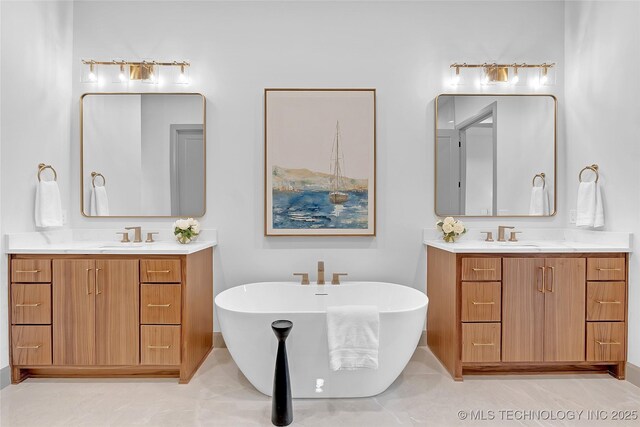 227 E 35th St, Tulsa, OK 74105 - bathroom featuring two vanities and a freestanding tub