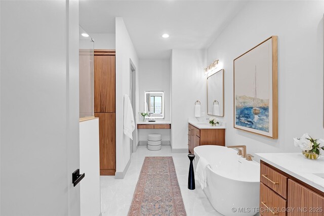 227 E 35th St, Tulsa, OK 74105 - full bathroom featuring two vanities, a freestanding bath, and recessed lighting