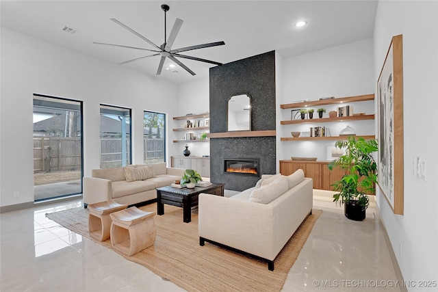 227 E 35th St, Tulsa, OK 74105 - living area with ceiling fan, a tile fireplace, recessed lighting, built in shelves, and baseboards
