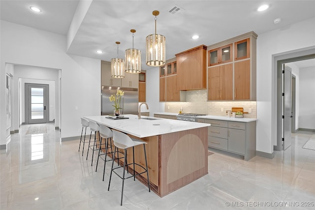 227 E 35th St, Tulsa, OK 74105 - kitchen with built in fridge, decorative backsplash, a sink, baseboards, and a large island with sink
