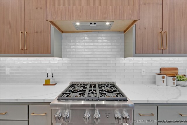 227 E 35th St, Tulsa, OK 74105 - kitchen featuring tasteful backsplash, light stone counters, and modern cabinets