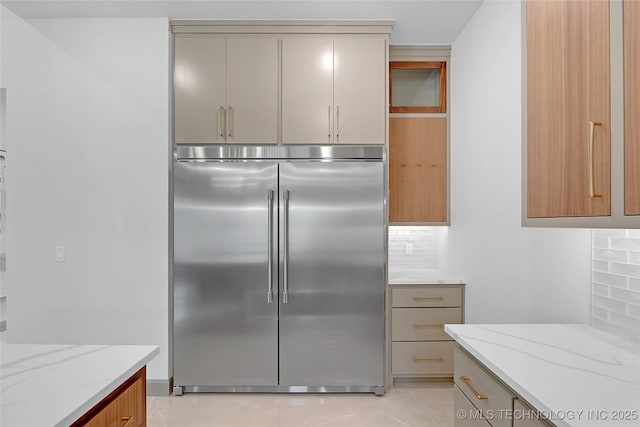227 E 35th St, Tulsa, OK 74105 - kitchen featuring stainless steel built in refrigerator, tasteful backsplash, and light stone countertops