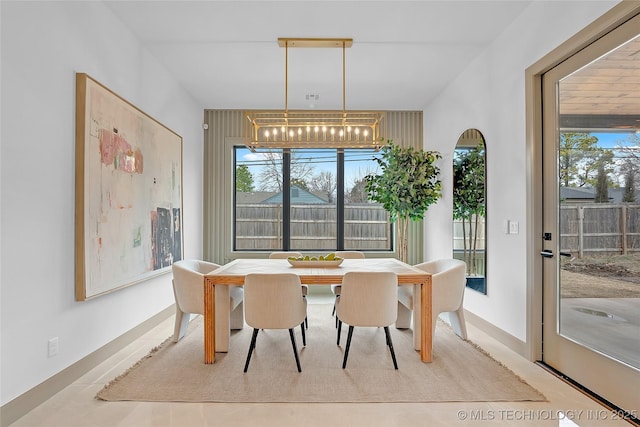 227 E 35th St, Tulsa, OK 74105 - dining room featuring a chandelier and plenty of natural light