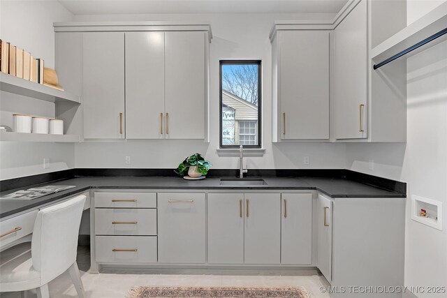 227 E 35th St, Tulsa, OK 74105 - kitchen featuring a sink, open shelves, and dark countertops