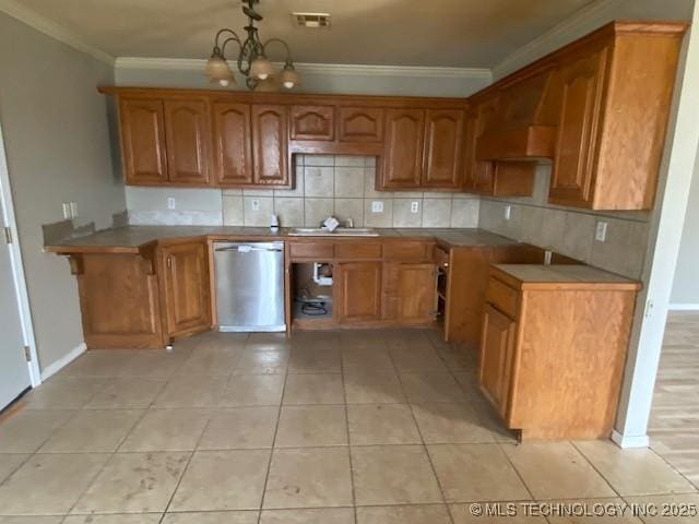 kitchen with ornamental molding, brown cabinets, backsplash, and stainless steel dishwasher