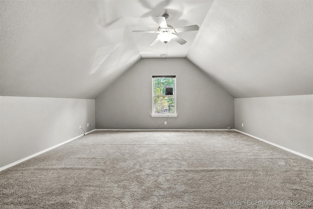 1474 S 271st W Ave, Sand Springs, OK 74063 - additional living space with a textured ceiling, vaulted ceiling, baseboards, a ceiling fan, and carpet floors