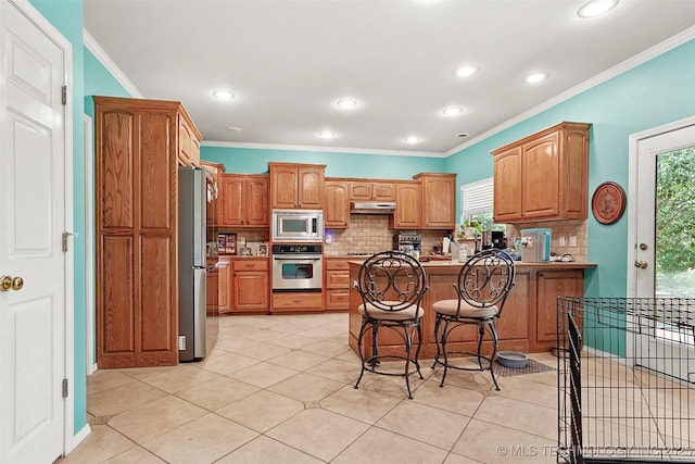 1474 S 271st W Ave, Sand Springs, OK 74063 - kitchen with crown molding, stainless steel appliances, under cabinet range hood, and tasteful backsplash