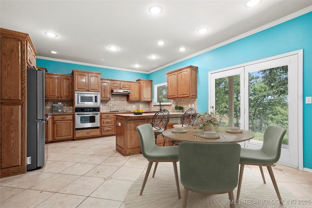 1474 S 271st W Ave, Sand Springs, OK 74063 - kitchen featuring appliances with stainless steel finishes, under cabinet range hood, tasteful backsplash, crown molding, and recessed lighting