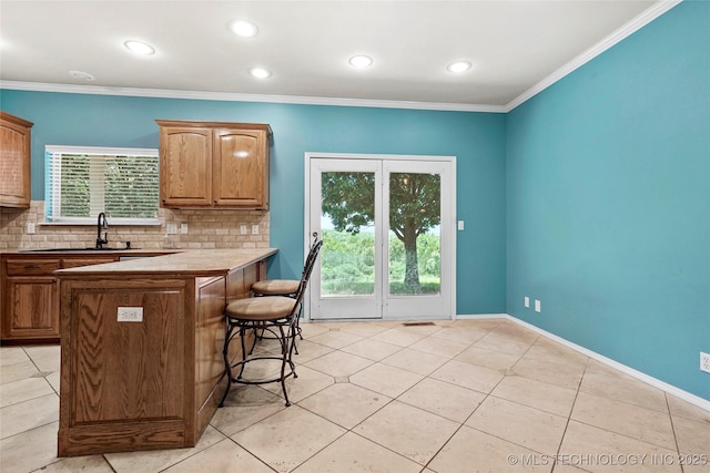 1474 S 271st W Ave, Sand Springs, OK 74063 - kitchen with a kitchen breakfast bar, decorative backsplash, light tile patterned flooring, recessed lighting, and a peninsula