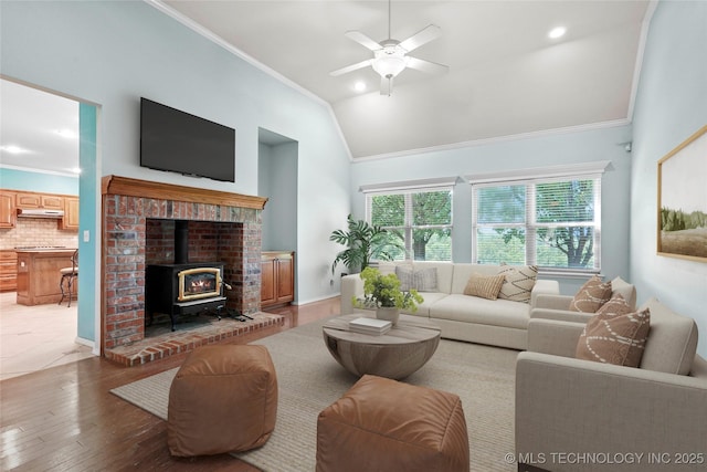 1474 S 271st W Ave, Sand Springs, OK 74063 - living area featuring a wood stove, ornamental molding, healthy amount of natural light, a ceiling fan, and light wood-type flooring