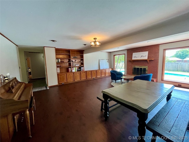 dining space with a brick fireplace