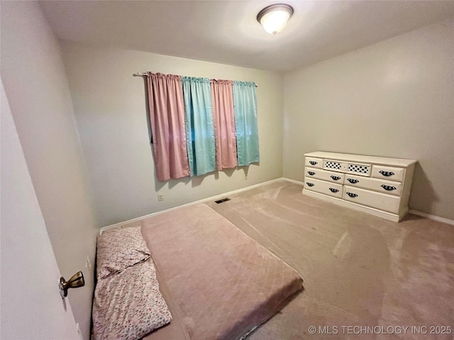 carpeted bedroom with baseboards and visible vents