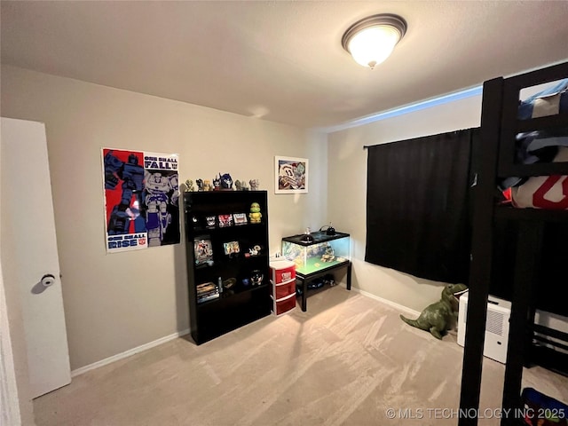 bedroom with carpet floors and baseboards