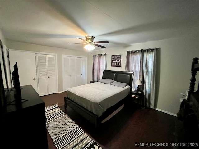 bedroom with baseboards, a ceiling fan, and multiple closets