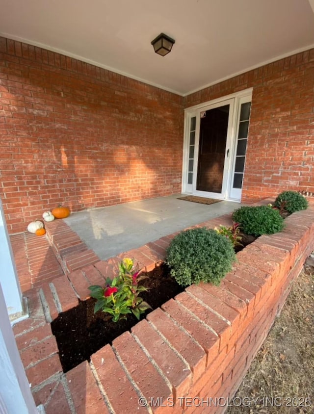 property entrance with brick siding