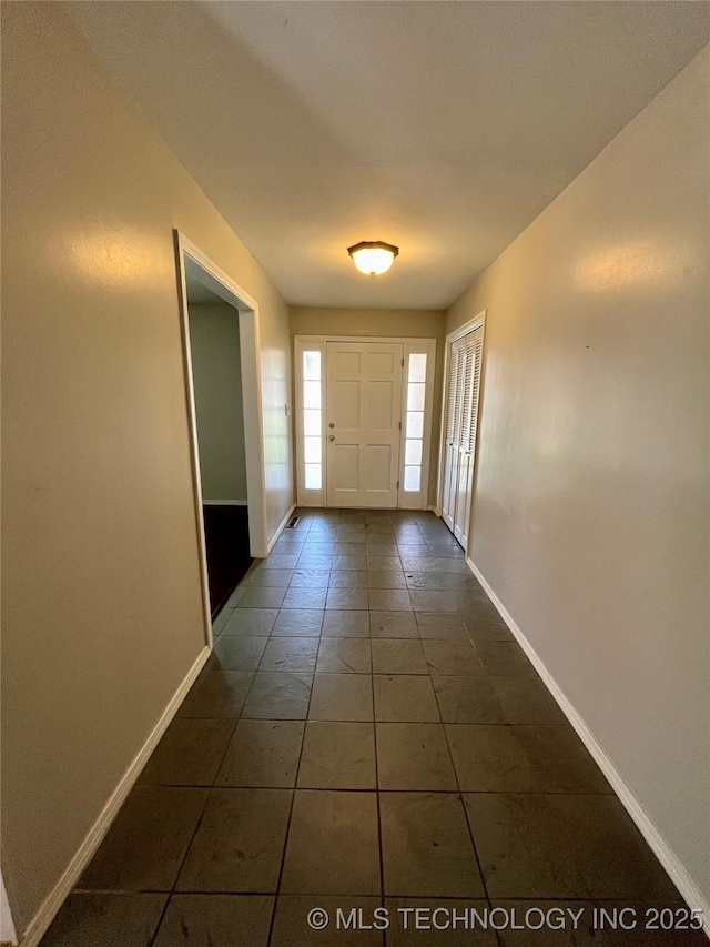 doorway to outside featuring baseboards