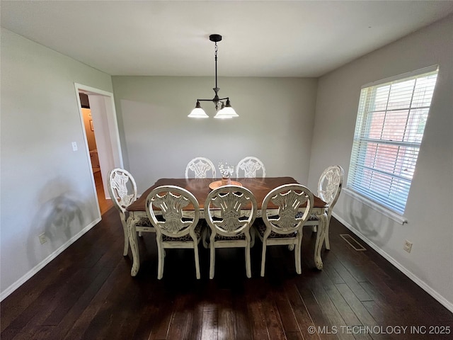 dining space featuring hardwood / wood-style flooring, visible vents, baseboards, and a notable chandelier