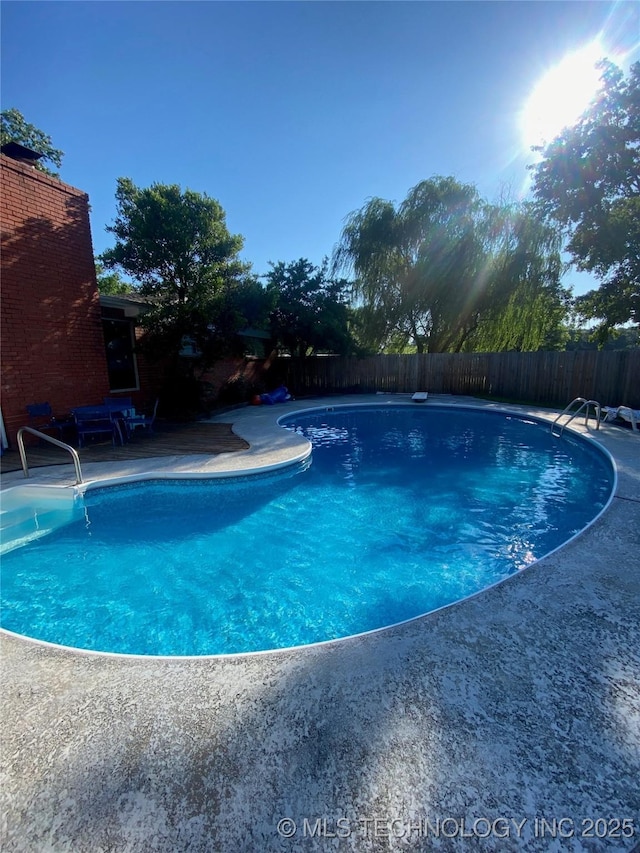 view of pool featuring a patio area, a fenced backyard, and a fenced in pool