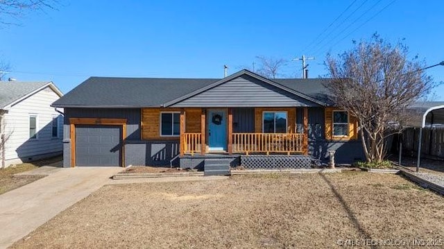 ranch-style house with a porch, concrete driveway, and a garage