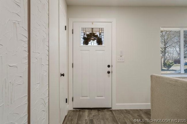 interior space with dark wood-style floors and baseboards