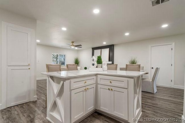 kitchen with recessed lighting, dark wood-type flooring, visible vents, white cabinets, and light countertops