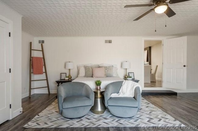 bedroom with visible vents, baseboards, ceiling fan, and wood finished floors