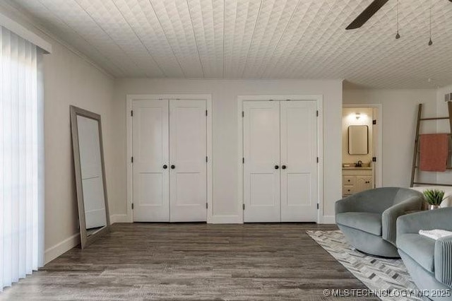 sitting room featuring ceiling fan, wood finished floors, wood ceiling, and baseboards