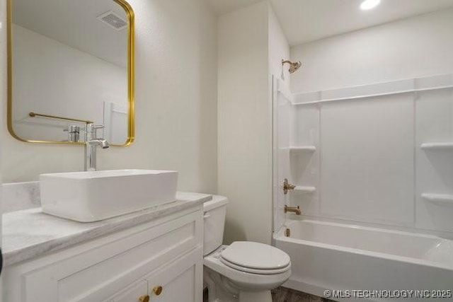 full bathroom with  shower combination, visible vents, vanity, and toilet