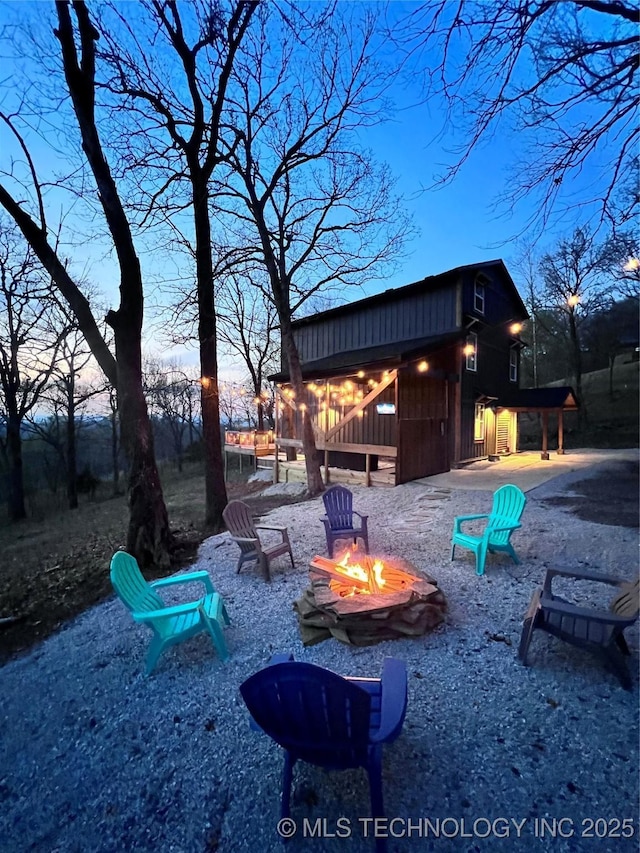 exterior space featuring a fire pit and an outbuilding