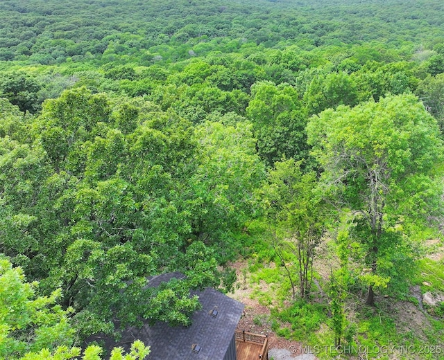 birds eye view of property with a view of trees